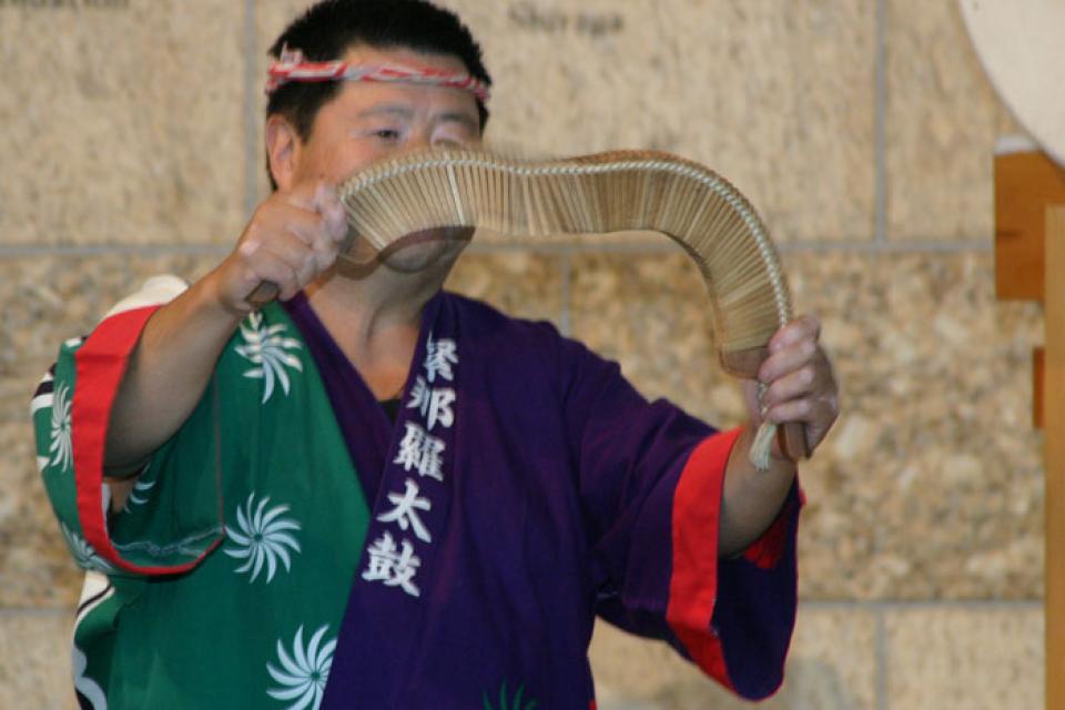 Johnny Mori holds a bin sasara in front of him to demonstrate